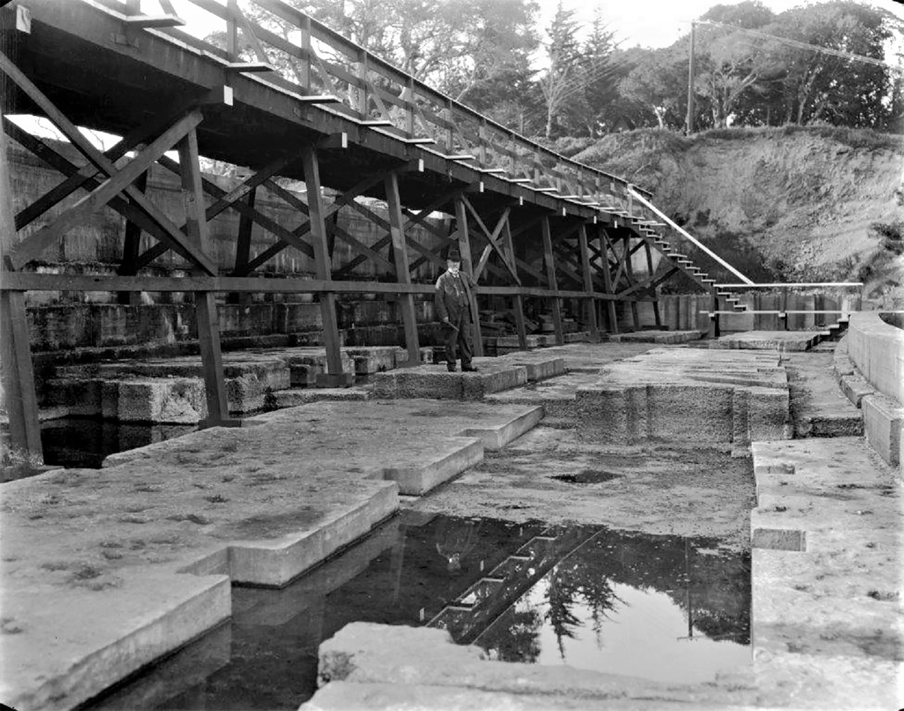 Man stands on interlocking concrete blocks. 