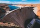 DISTANCE SHOT OF A LARGE DAM AND THE RESERVOIR BEHIND IT