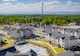 aerial view of a community with houses, apartments and a pool